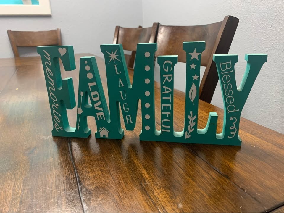 Decorative wood cutout with vinyl decals “Family,” approx. 13.25” x 6.5” Teal