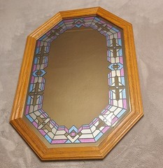 vintage wood-framed octagonal mirror featuring faux stained glass with pink and