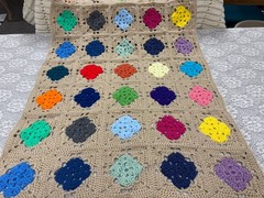 Handmade colorful beige background granny square shabby chic crocheted knitted a