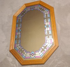 vintage wood-framed octagonal mirror featuring faux stained glass with pink and