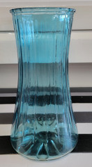 TEAL BLUE MULTIPANELED GLASS FLOWER VASE 9 INCHES DIAMETER 3.75 INCHES