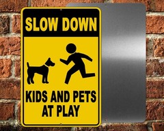 Kids and Pets at Play Slow Down Metal Sign warning children in area