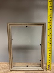 8 x 5.5 in silver frame with glass, simple double rounded profile.