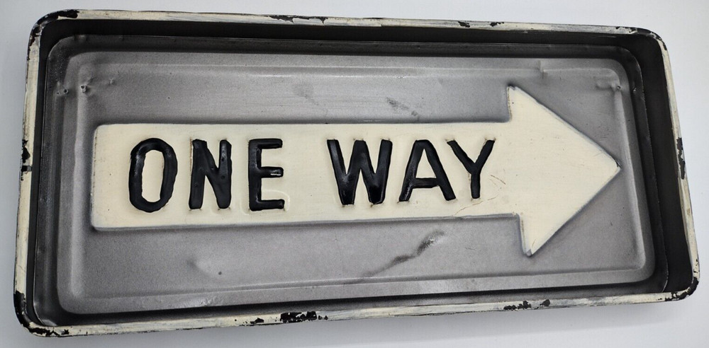 One way metal sign 16 inch long and 1 inch deep with hangers on back.