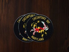 Dark Grey Background With Yellow, Red, White, and Black Crab. Yellow Lettering.